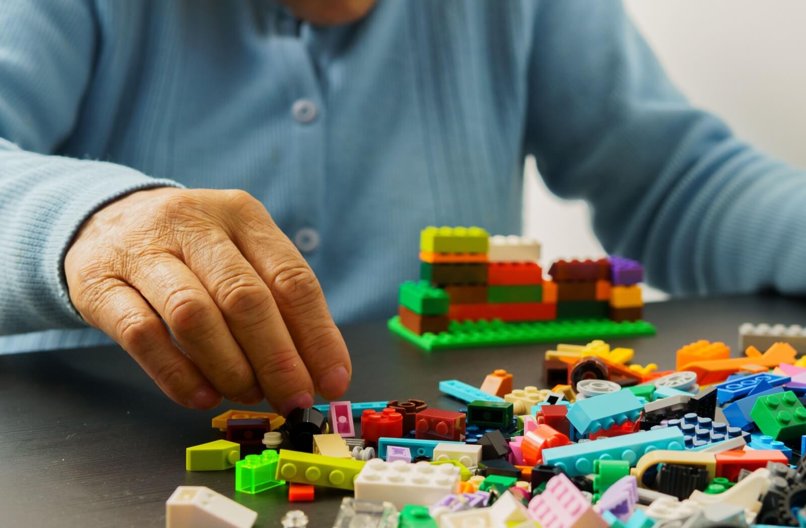 An older adult does a puzzle to support healthy aging with memory-friendly activities.